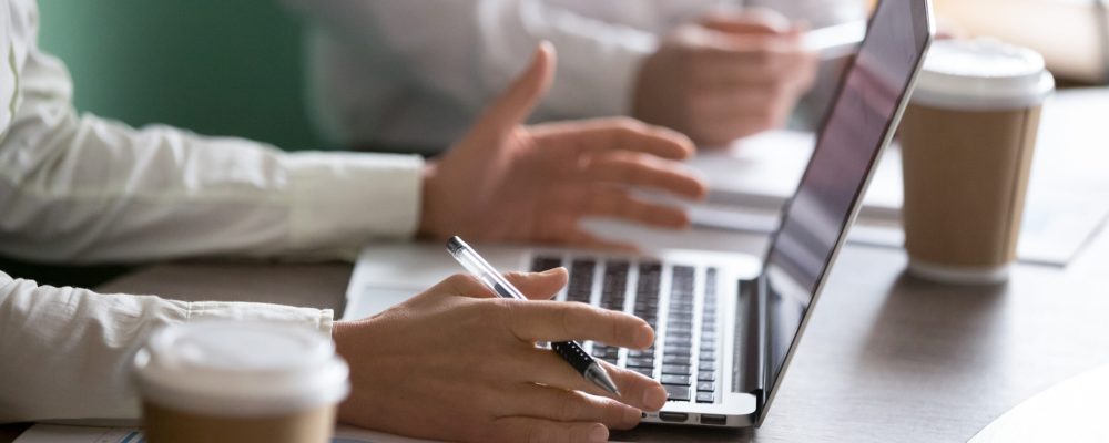 Businesswoman using laptop presenting project statistics report or market analysis at meeting, making offer or financial forecast, consulting clients, discussing work or negotiating, close up view